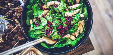 a spinach, cranberry and chicken salad: part of a whole food diet