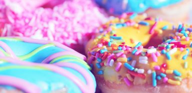 A plate of brightly colored doughnuts