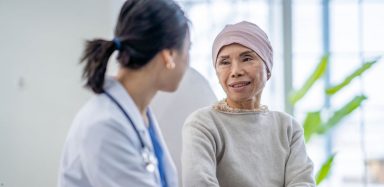 A cancer patient sitting with her doctor.